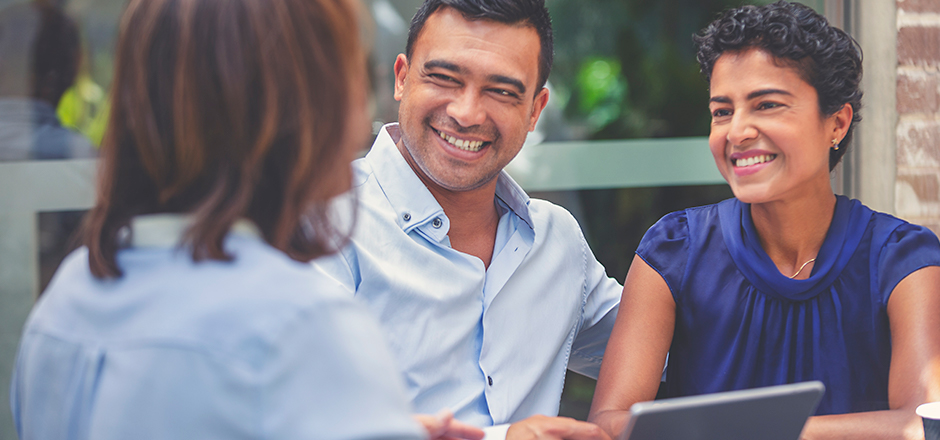 couple with a financial advisor discussing finances