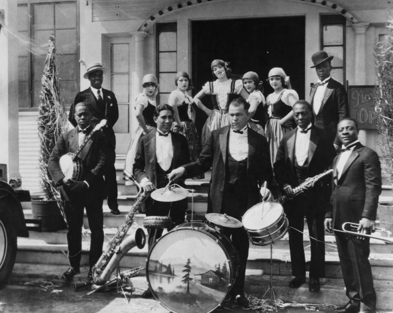 Black band poses with dancers