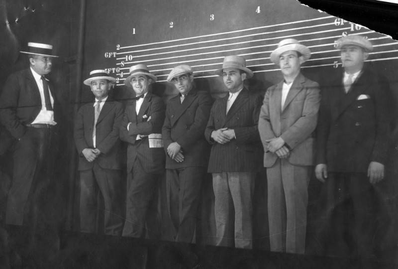 six men in hats lined up in the Los Angeles police shadowbox