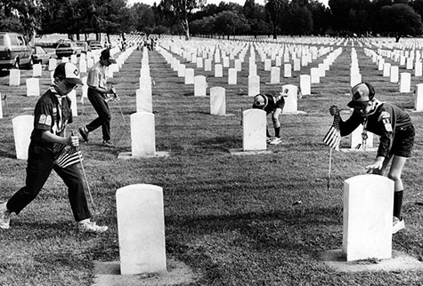 Boy Scouts place flags on each of the 77,000 graves at the Veterans National Cemetery in Westwood in observance of Memorial Day.