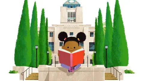 A child reads a book in the garden with the Central Library behind them.