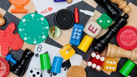 a close up of a variety of game pieces on top of a chess board