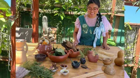 Taty showing clay figurines on a table