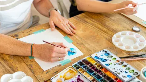 a close up of an adult watercolor painting on a table